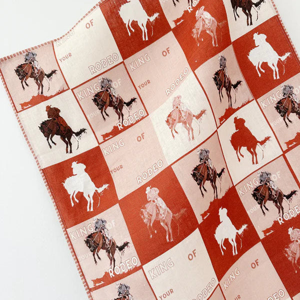 Quilt with cowboy and horse pattern on a white background