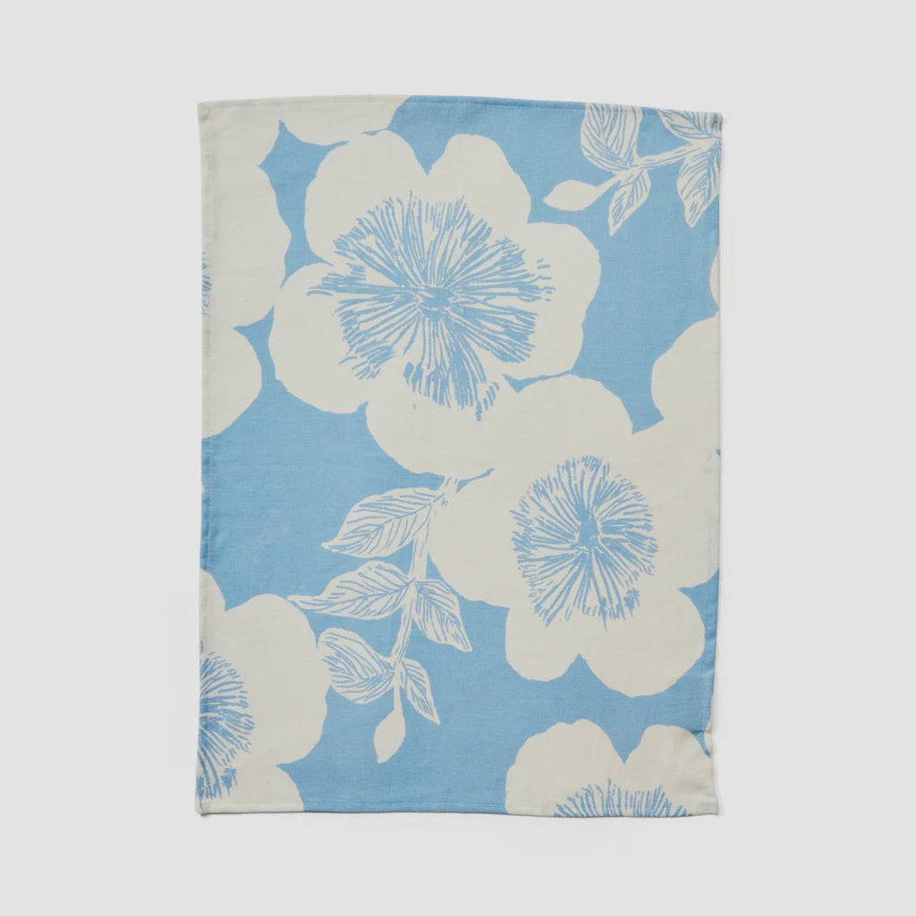 Floral patterned fabric swatch with blue and white flowers on a light gray background