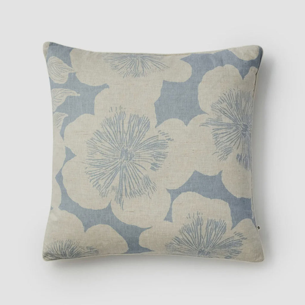 Decorative pillow with floral pattern on a light gray background