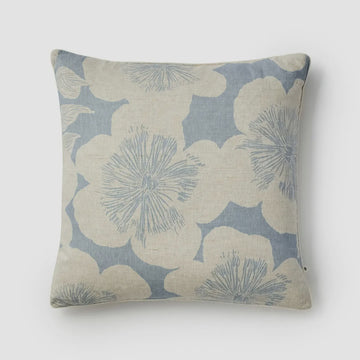 Decorative pillow with floral pattern on a light gray background